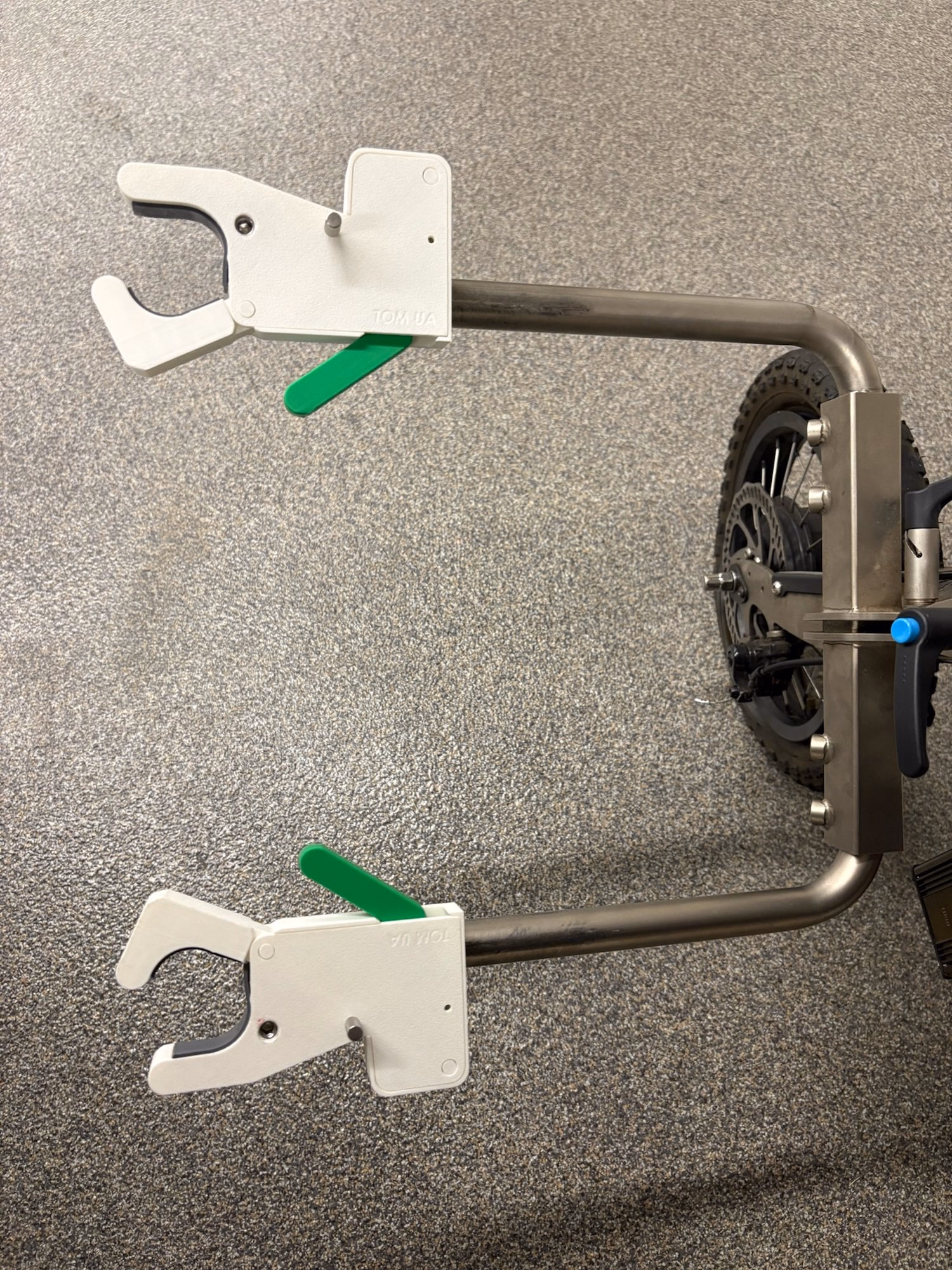 Two physical QuickClamp prototypes mounted to a wheelchair frame