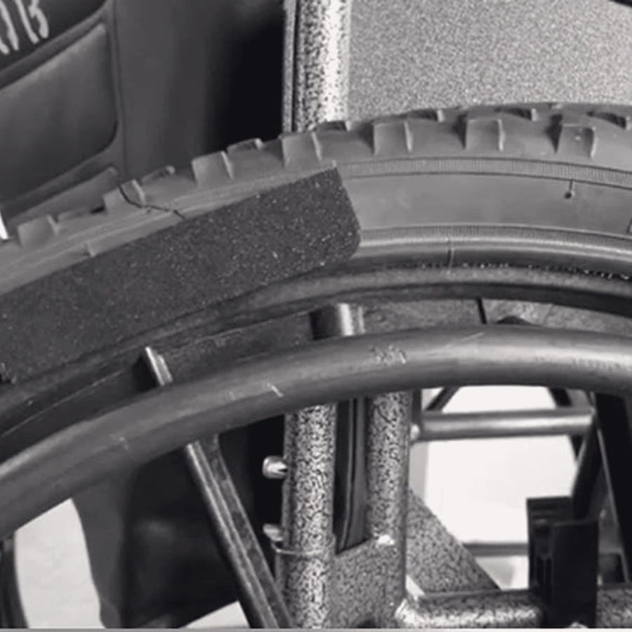 Close-up of removable tread wrapped around a wheelchair wheel